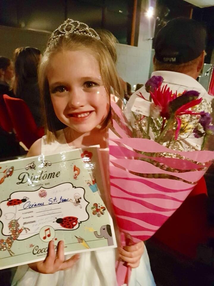 Élève fière avec son diplôme et ses fleurs